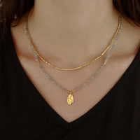 Faceted gold nugget bead necklace with a labradorite and gold hammered teardrop pendant.