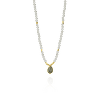 Elegant moonstone pendant with a gold setting and rough diamond accent.