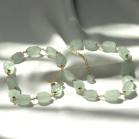 Aquamarine tumbled gemstone necklace styled for a chic look, featuring vibrant natural stones in a refreshing hue, perfect for a modern, elegant accessory.