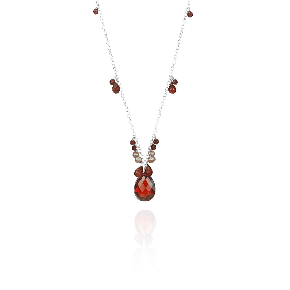 Garnet, zircon, and pearl pendant, elegantly designed to highlight the rich gemstone combination.