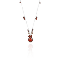 Garnet, zircon, and pearl pendant, elegantly designed to highlight the rich gemstone combination.