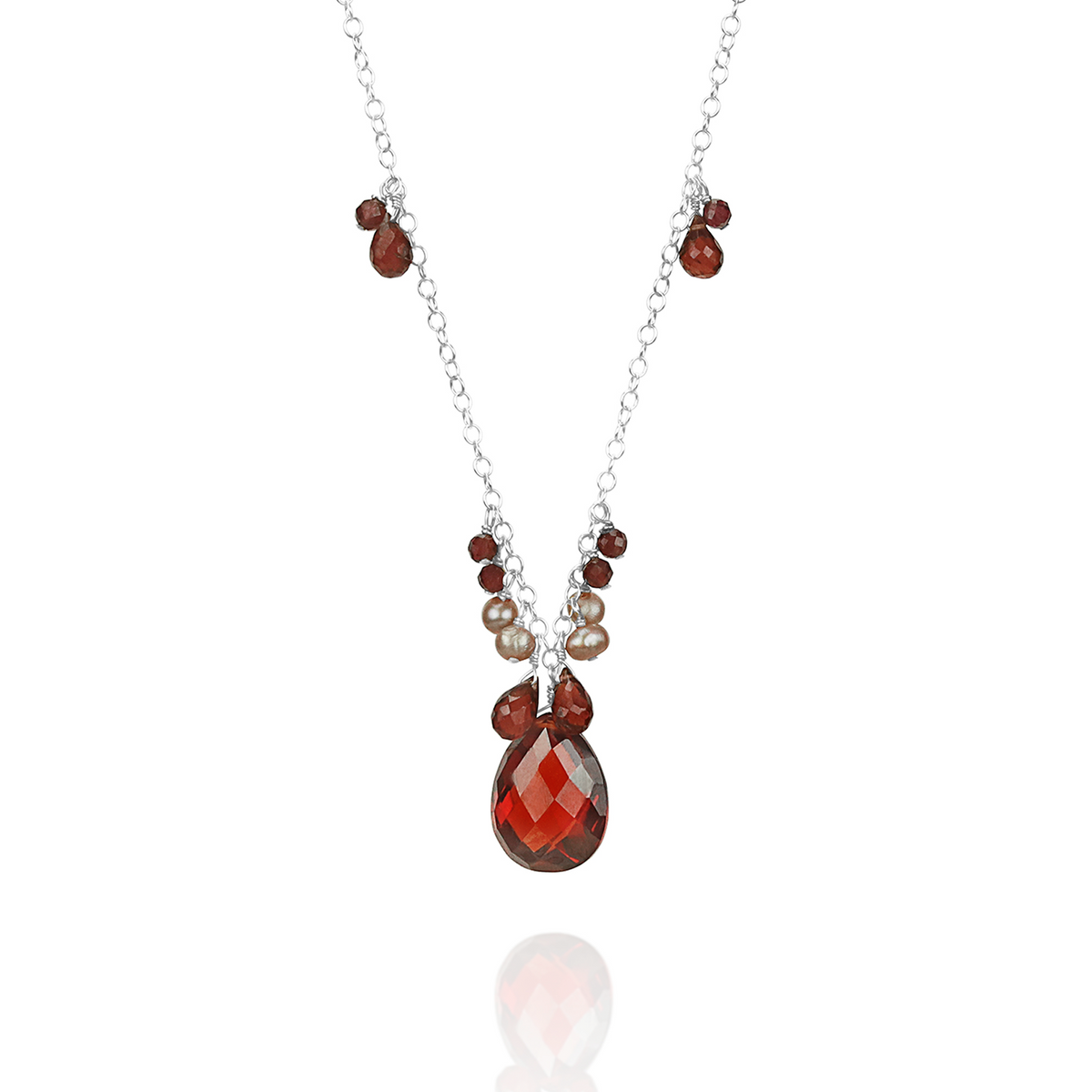 Elegant garnet, zircon, and pearl pendant, showcasing a stunning combination of gemstones in a refined design.