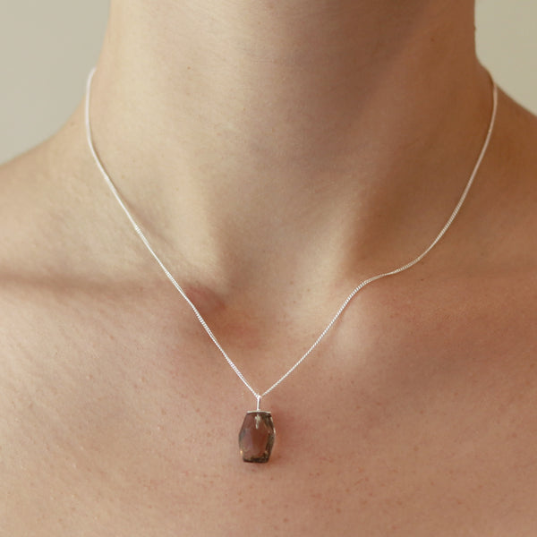 Geometric gemstone necklace worn on model, showcasing a modern design with bold gemstones, perfect for adding a contemporary statement to any outfit.