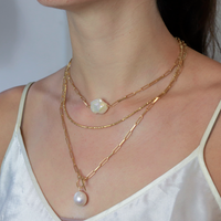 Elegant gold layering necklace, perfect for creating a chic, stacked look or wearing alone for a subtle statement.