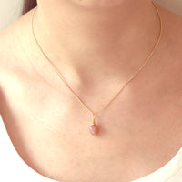 Small acorn pendant necklace worn on model, featuring a delicate design perfect for adding a subtle, elegant touch to any outfit.