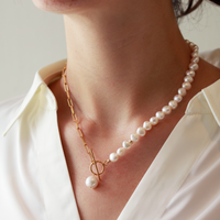 White pearl and paperclip chain toggle necklace worn on model, showcasing a modern design with elegant pearls and a stylish toggle clasp for a chic, contemporary look.